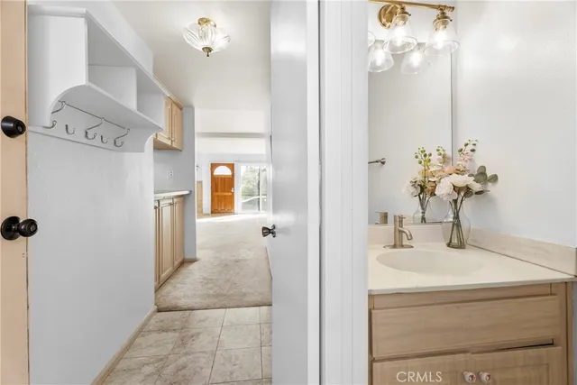 a bathroom with a sink vanity and a mirror