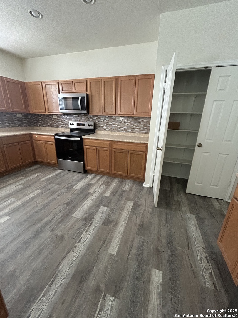 11111 Denae Drive Live Oak, TX 78233 - Photo 12 of 43 a kitchen with stainless steel appliances a sink and a stove