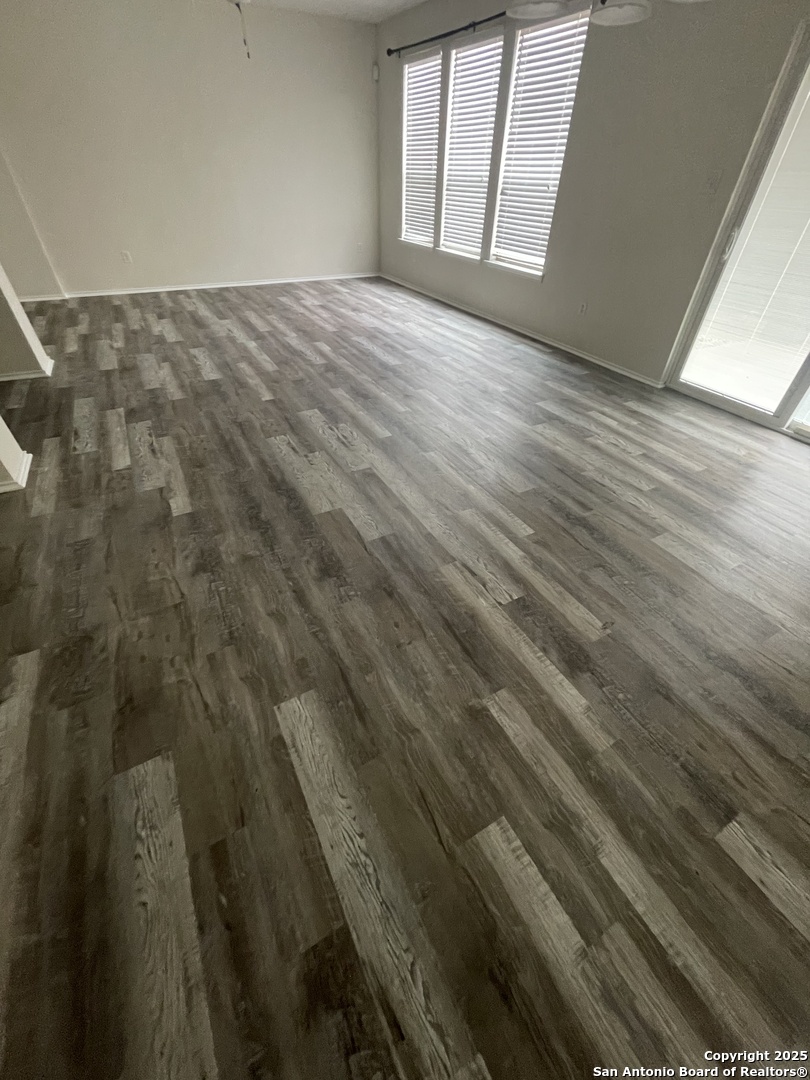 11111 Denae Drive Live Oak, TX 78233 - Photo 8 of 43 a view of empty room with wooden floor and fan