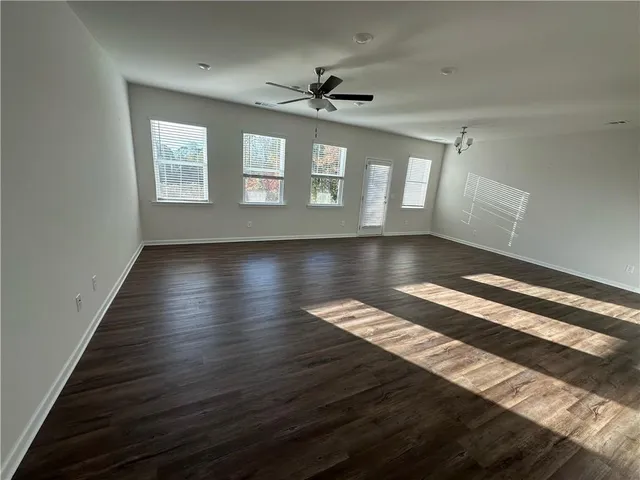 a view of wooden floor and windows in a room