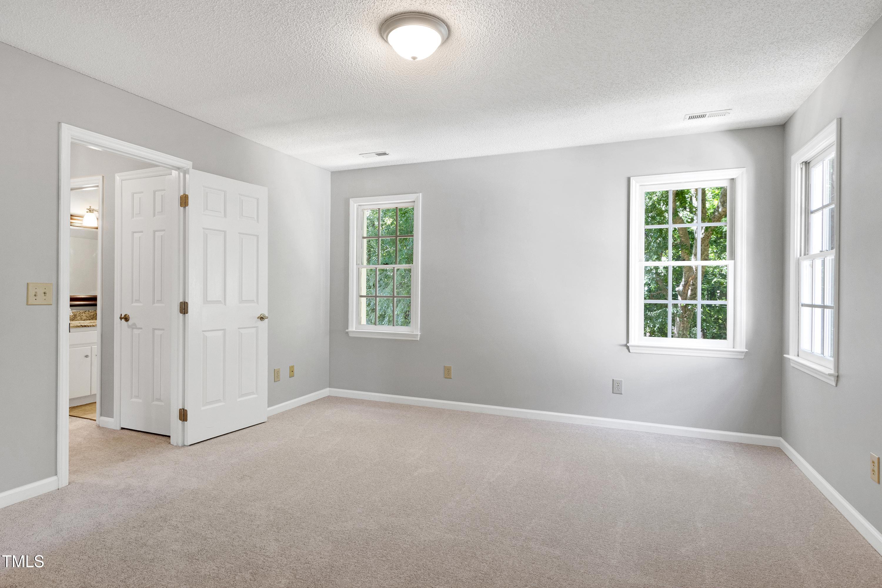 300 Silvercliff Trail Cary, NC 27513 - Photo 12 of 27 an empty room with windows and closet
