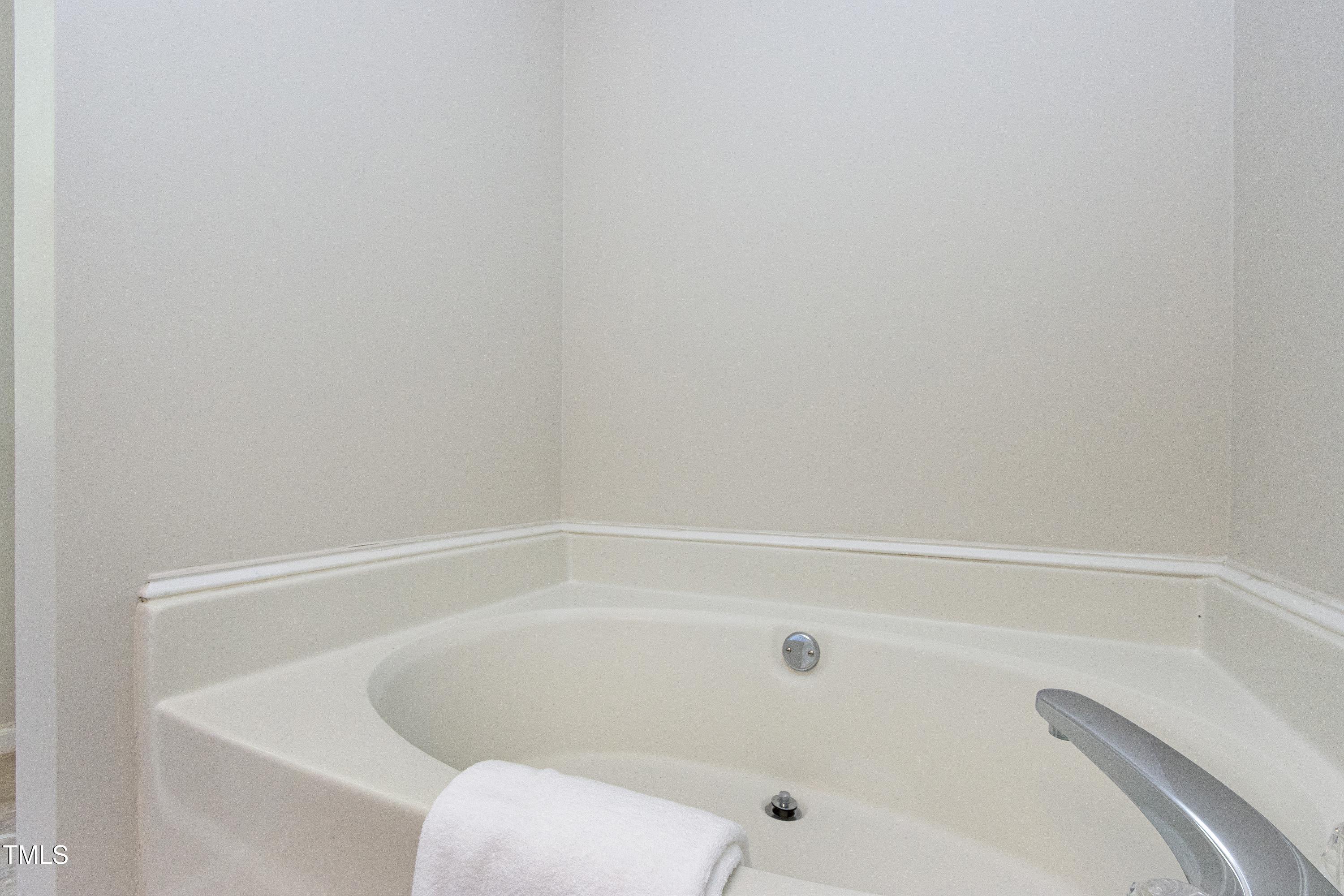300 Silvercliff Trail Cary, NC 27513 - Photo 14 of 27 a close up of a bathtub in a bathroom