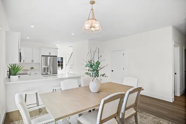 a dining room with furniture and potted plants