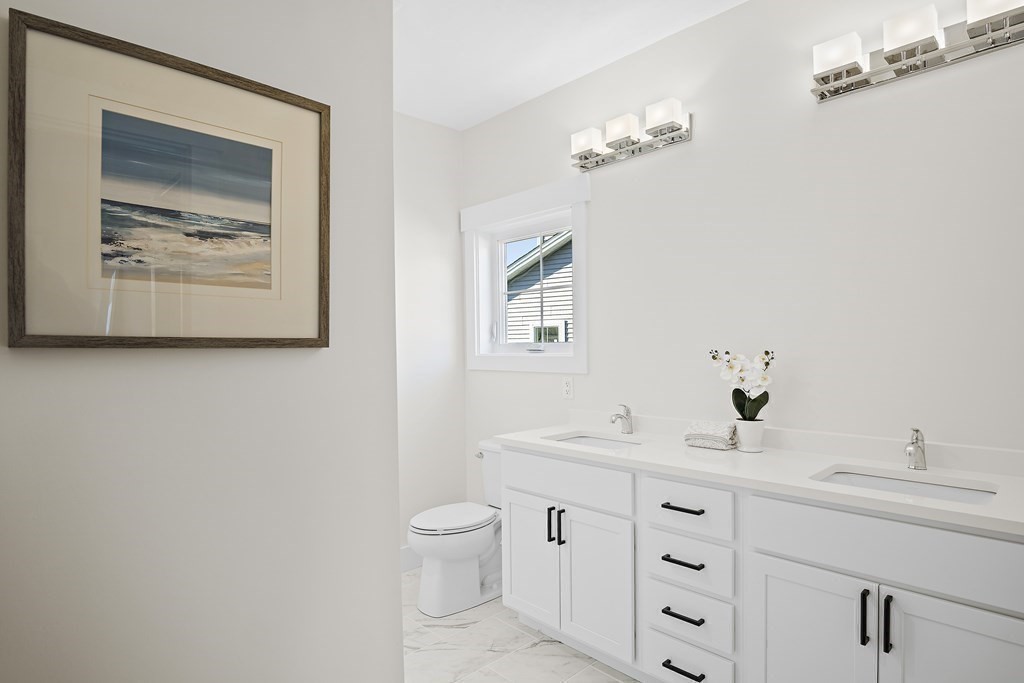 25 Salisbury Hill Boulevard, Unit 64 Worcester, MA 01609 - Photo 21 of 41 a bathroom with a toilet a sink and mirror