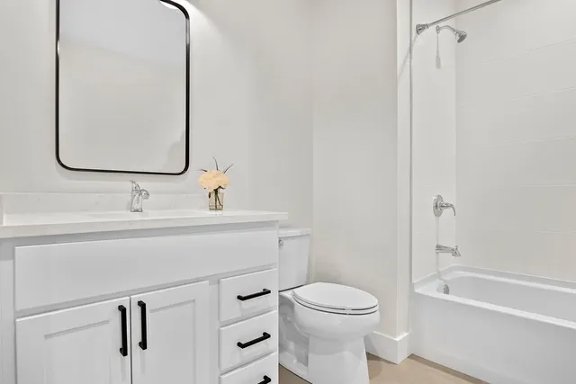 a bathroom with a sink vanity and a mirror