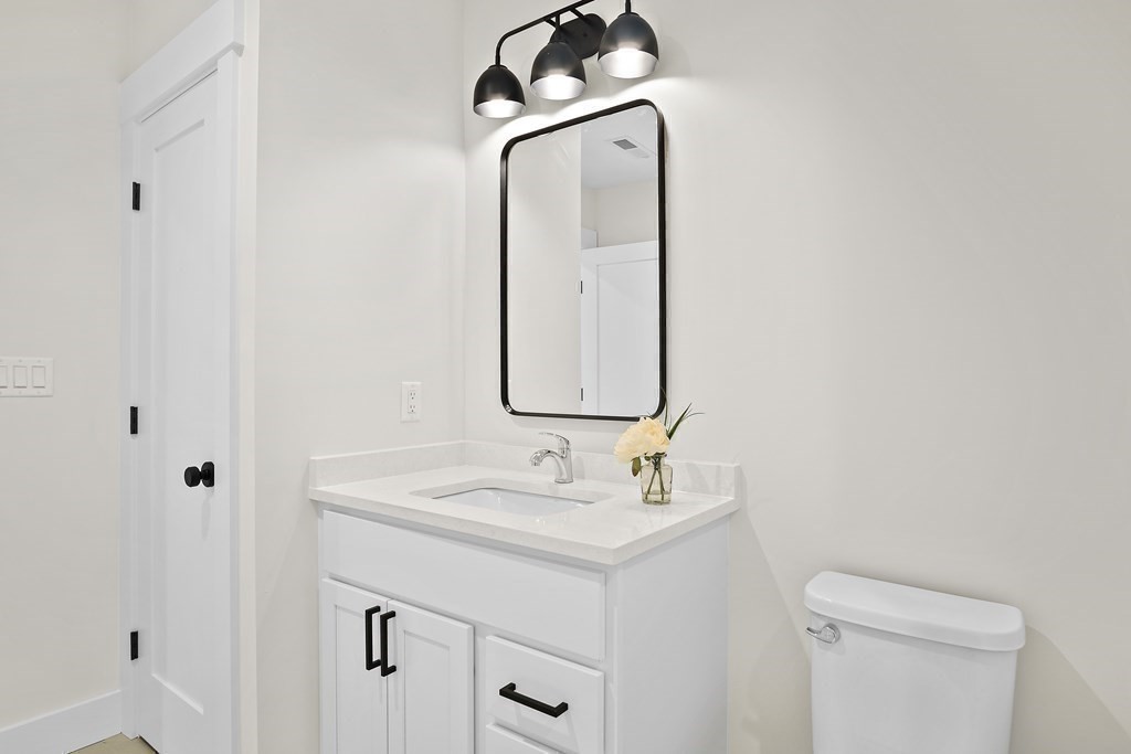 25 Salisbury Hill Boulevard, Unit 64 Worcester, MA 01609 - Photo 24 of 41 a bathroom with a sink vanity and a mirror