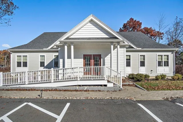 a living room with furniture and a book shelf