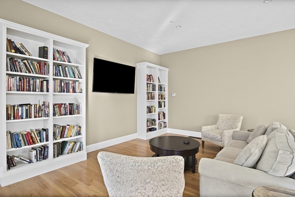 25 Salisbury Hill Boulevard, Unit 64 Worcester, MA 01609 - Photo 31 of 41 a living room with furniture and a book shelf