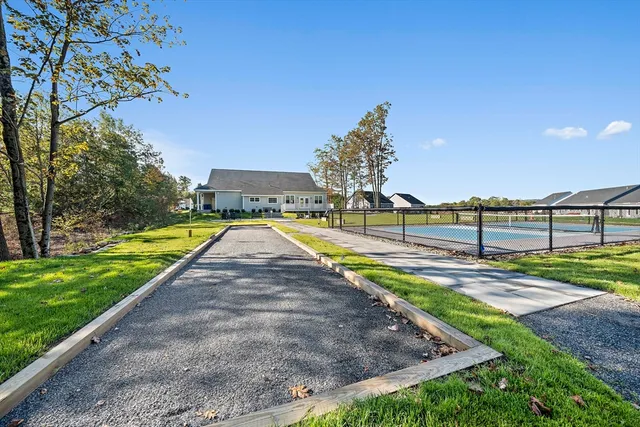 a view of a house with swimming pool and sitting area