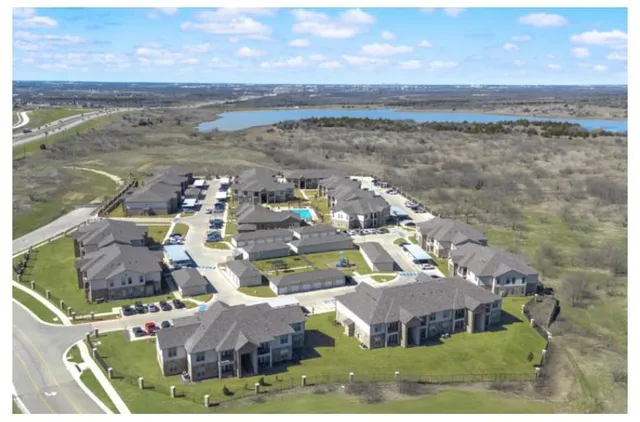 a kitchen with granite countertop a refrigerator stove and microwave