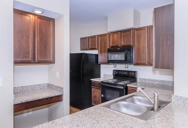 a kitchen with a sink stainless steel appliances and cabinets
