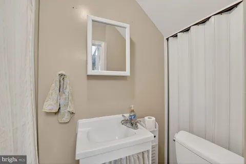 a bathroom with a shower curtain and a sink