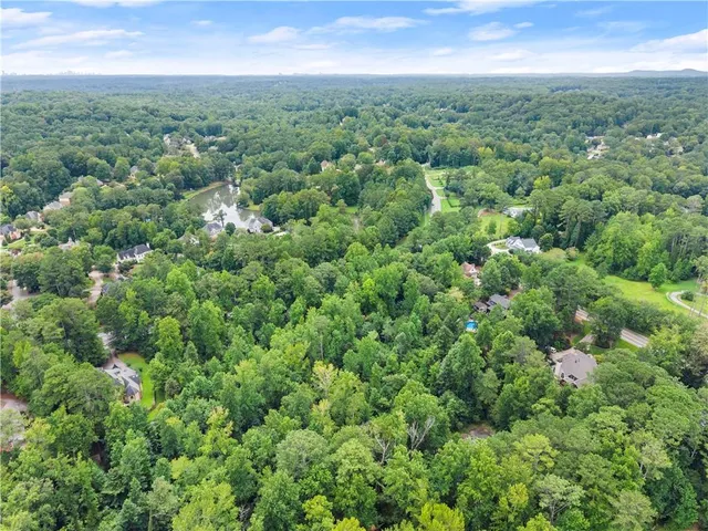 a view of a green field with lots of bushes