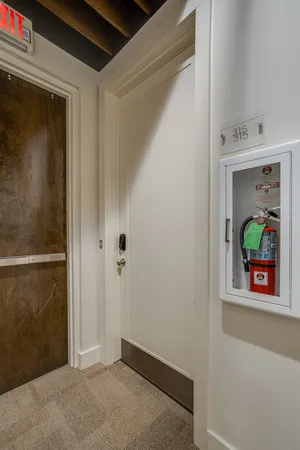 a view of a hallway with wooden floor and closet