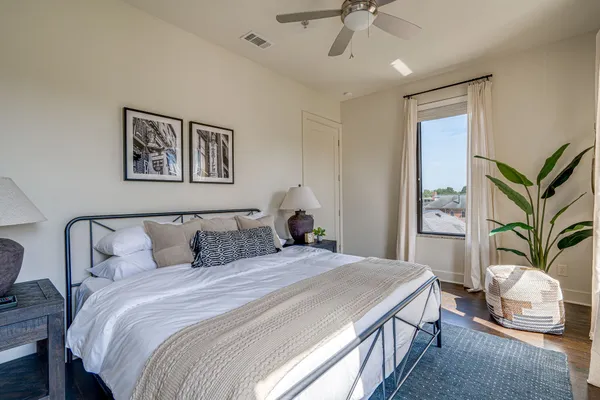 a bedroom with a large bed and a chandelier