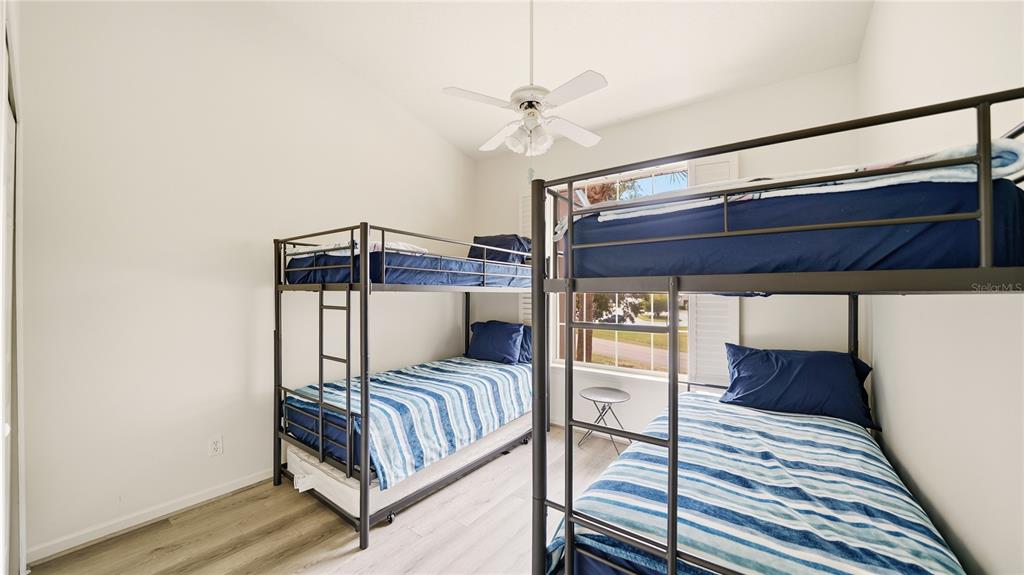 705 Augusta Circle, Unit 705 St. Augustine, FL 32086 - Photo 31 of 53 a bedroom with a bed and a ceiling fan