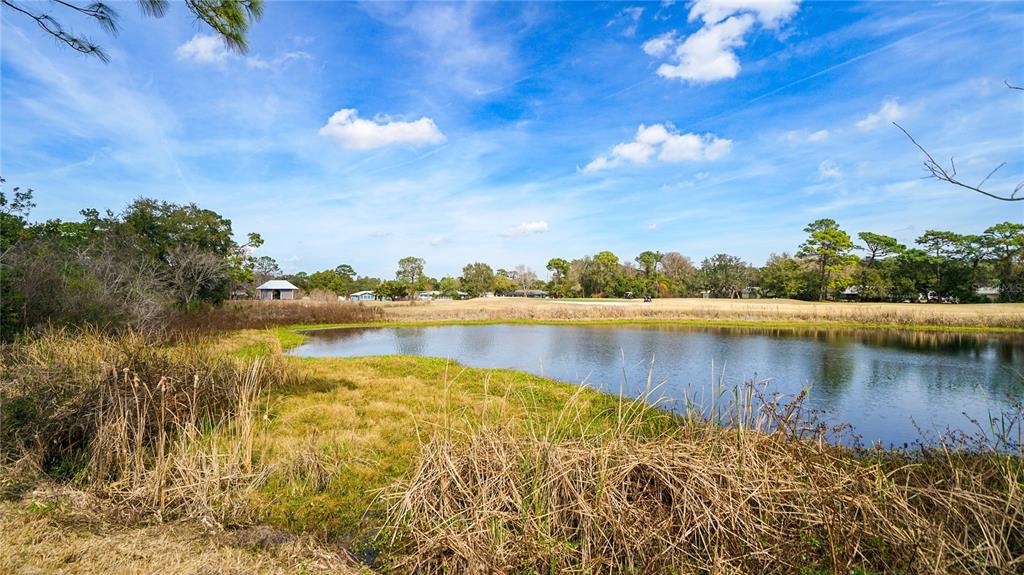 705 Augusta Circle, Unit 705 St. Augustine, FL 32086 - Photo 42 of 53 a view of a lake with houses in the back