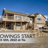 a view of a white house with large windows