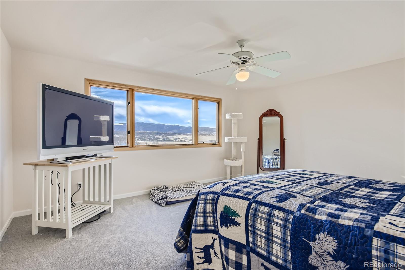 3961 Bear Canyon Circle Sedalia, CO 80135 - Photo 14 of 40 a bedroom with a bed and a chandelier