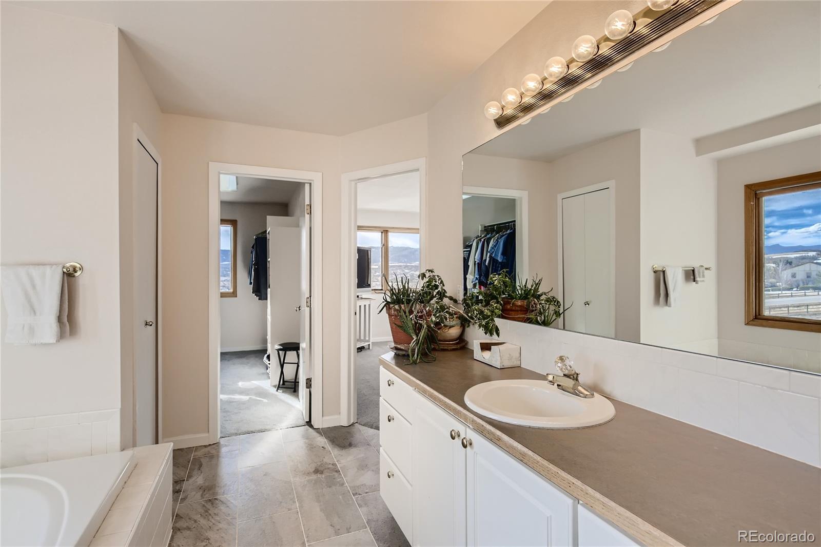3961 Bear Canyon Circle Sedalia, CO 80135 - Photo 17 of 40 a bathroom with a sink double vanity and shower