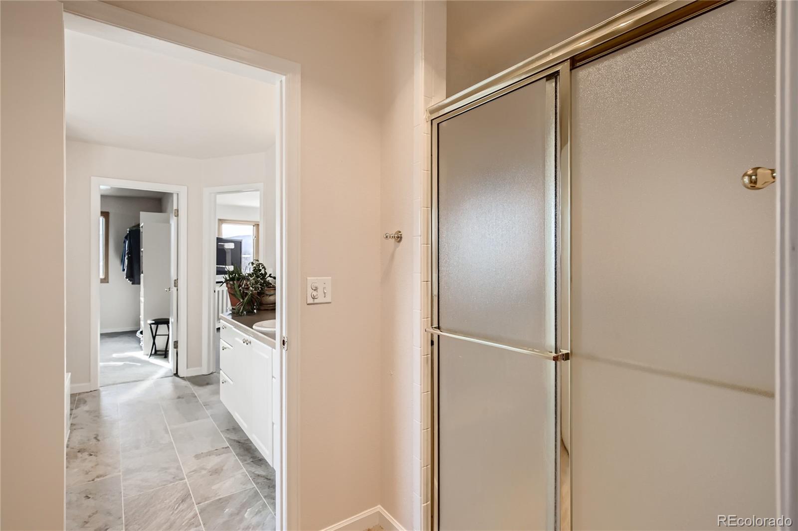 3961 Bear Canyon Circle Sedalia, CO 80135 - Photo 18 of 40 a view of a bathroom with a glass door shower
