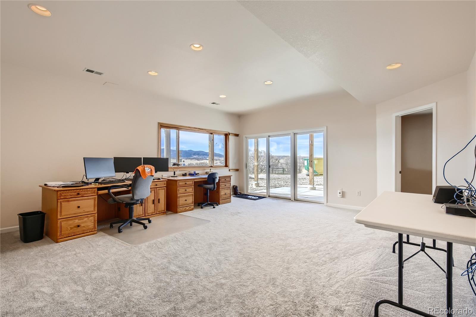 3961 Bear Canyon Circle Sedalia, CO 80135 - Photo 22 of 40 a view of a workspace with furniture and a window