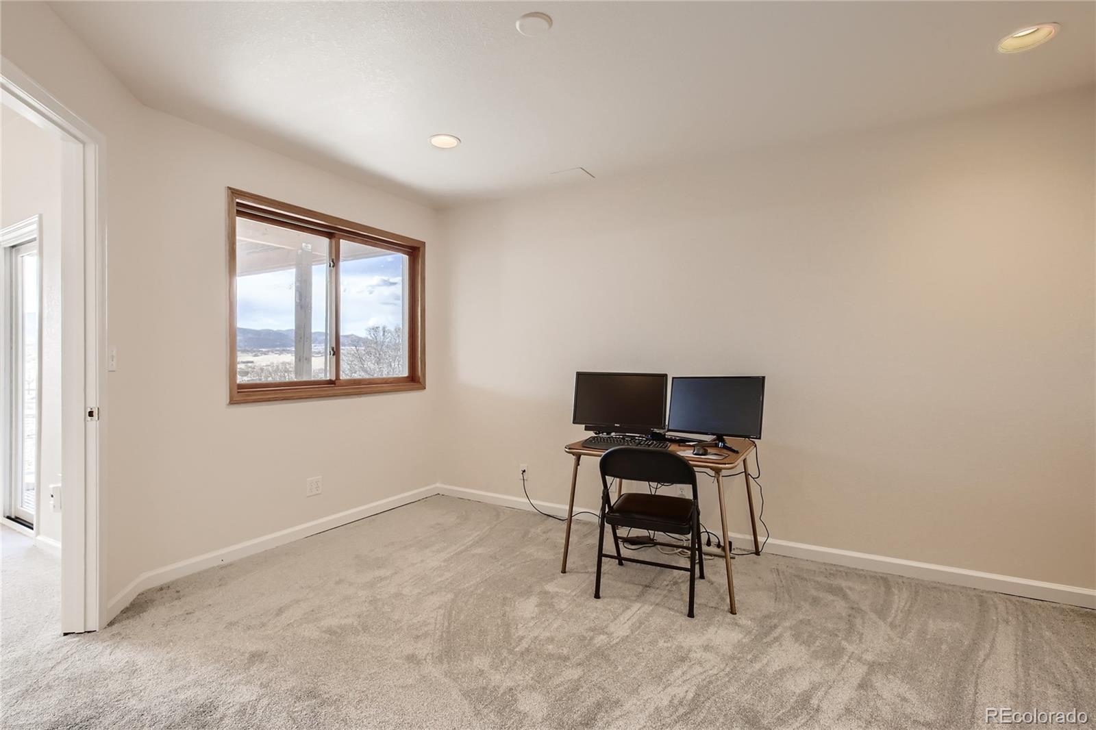 3961 Bear Canyon Circle Sedalia, CO 80135 - Photo 23 of 40 a view of a workspace with furniture and a window