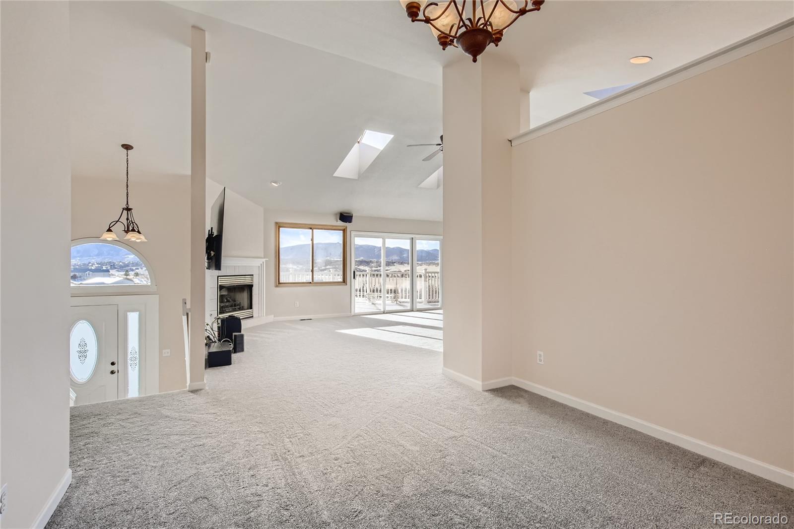 3961 Bear Canyon Circle Sedalia, CO 80135 - Photo 7 of 40 a view of a kitchen with furniture and a chandelier
