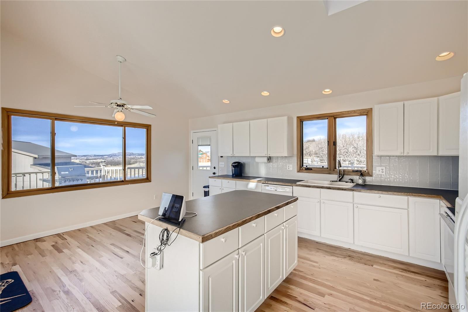 3961 Bear Canyon Circle Sedalia, CO 80135 - Photo 9 of 40 a kitchen with a sink stove and cabinets