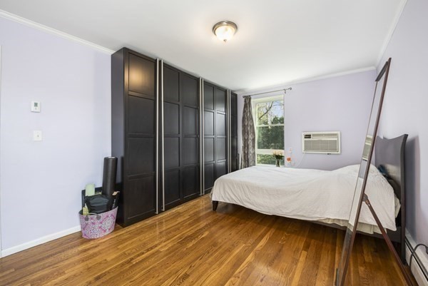 16 Addington Road, Unit 46 Brookline, MA 02445 - Photo 12 of 24 a bedroom with a bed and wooden floor