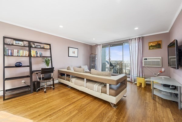 16 Addington Road, Unit 46 Brookline, MA 02445 - Photo 18 of 24 a living room with furniture and a wooden floor