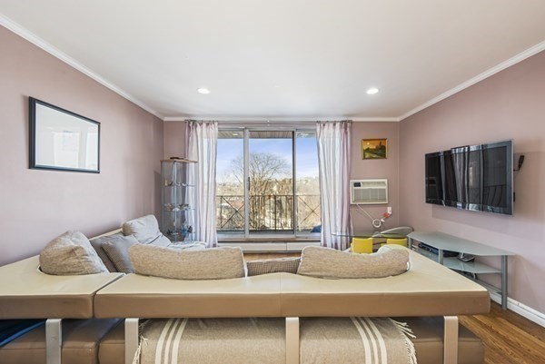 16 Addington Road, Unit 46 Brookline, MA 02445 - Photo 3 of 24 a bedroom with furniture and a flat screen tv