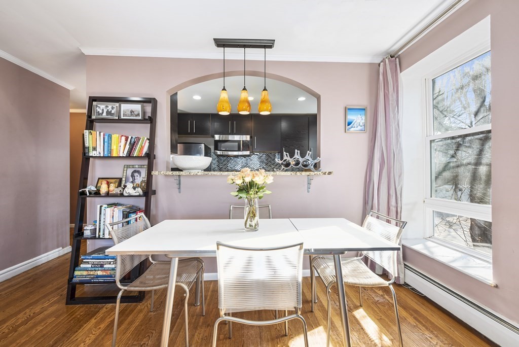 16 Addington Road, Unit 46 Brookline, MA 02445 - Photo 4 of 24 a view of a dining room with furniture a chandelier and wooden floor