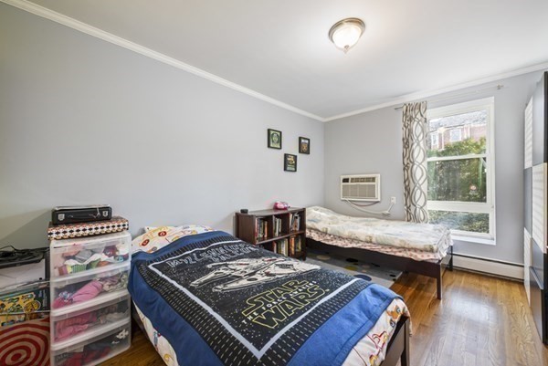 16 Addington Road, Unit 46 Brookline, MA 02445 - Photo 8 of 24 a bedroom with furniture and a wooden floor