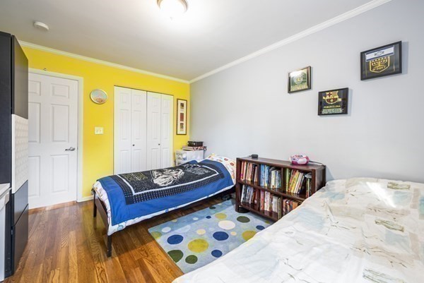 16 Addington Road, Unit 46 Brookline, MA 02445 - Photo 9 of 24 a bedroom with a bed and wooden floor