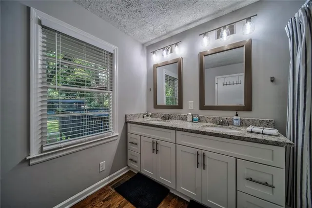 a bathroom with a double vanity sink and a mirror