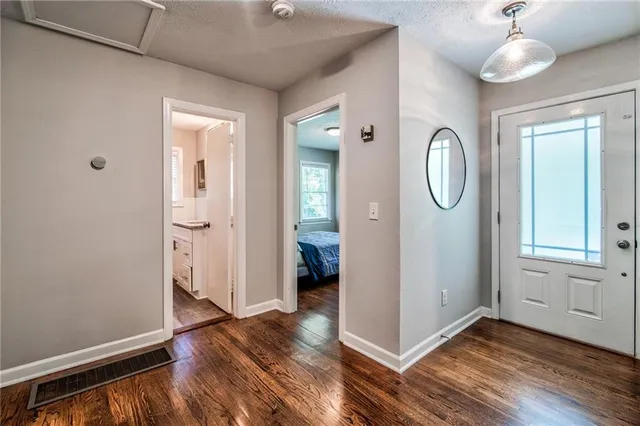a view of a room with wooden floor and bathroom