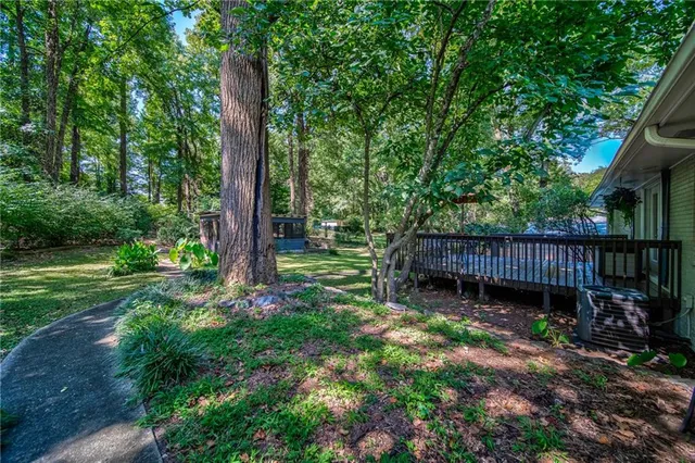 a view of a house with backyard and sitting area