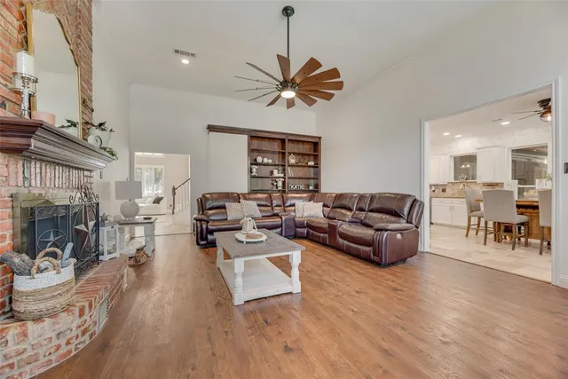 a living room with furniture a dining table and a fireplace