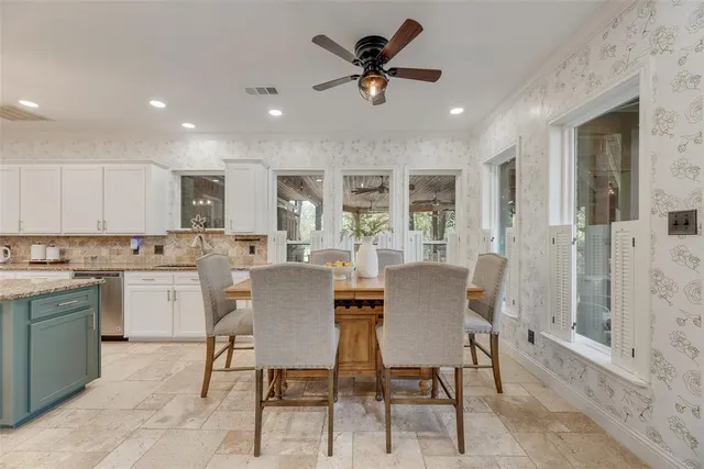 a view of a dining room with furniture and a chandelier