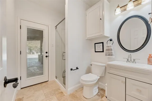a bathroom with a toilet a sink and a mirror