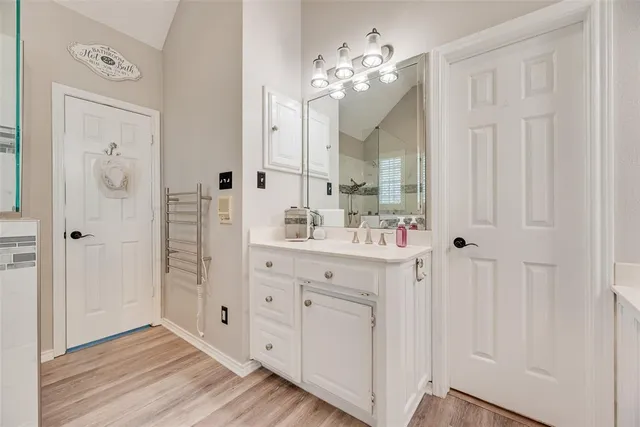 a bathroom with a sink vanity and a mirror