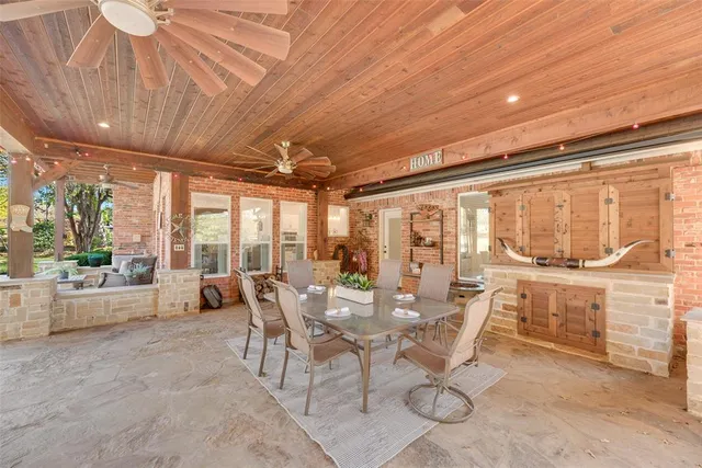 a dining room with furniture and large windows