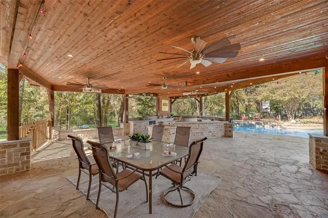 a view of a dining room with furniture large windows and wooden floor