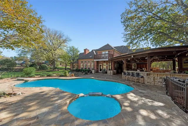 a view of a house with swimming pool and sitting area