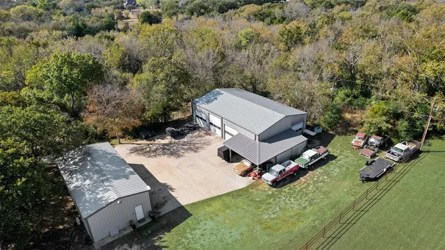 an aerial view of a house with a yard