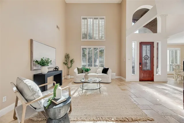 a living room with furniture and a potted plant