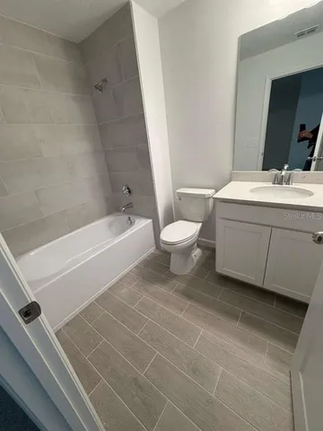a bathroom with a sink a toilet and bathtub