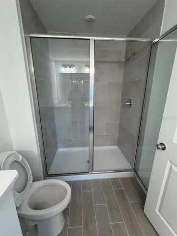 a bathroom with a shower and a toilet