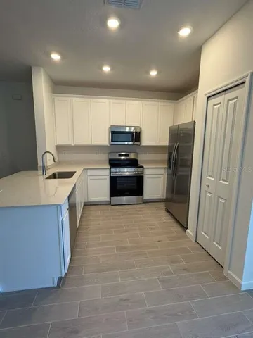 a kitchen with a refrigerator and a sink